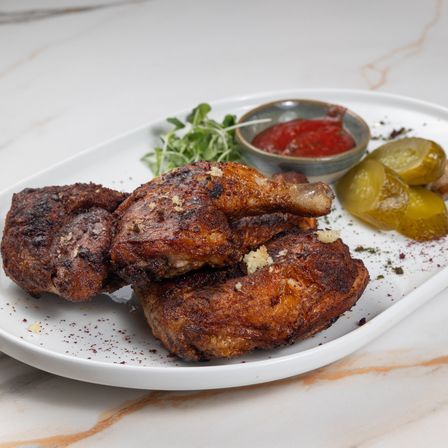 Chicken tabaka with pickles, microgreens and tomato sauce